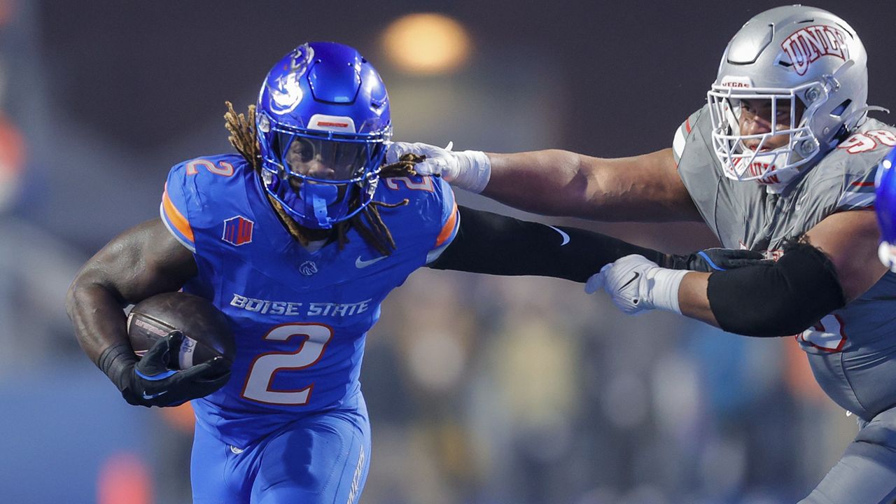 Boise State running back Ashton Jeanty pushed away from the arms of UNLV defensive lineman Tatuo Martinson during the Mountain West football championship game on Friday in Boise, Idaho.