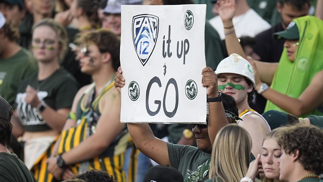 A Colorado State fan held up a sign to mark the school's move to the Pac-12 Conference from the Mountain West during CSU's game against Colorado on Sept. 14 in Fort Collins, Colo.