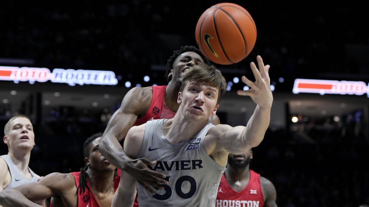 Xavier forward Gytis Nemeiksa tried to fend off Houston's LJ Cryer from the basketball in Cincinnati in December.