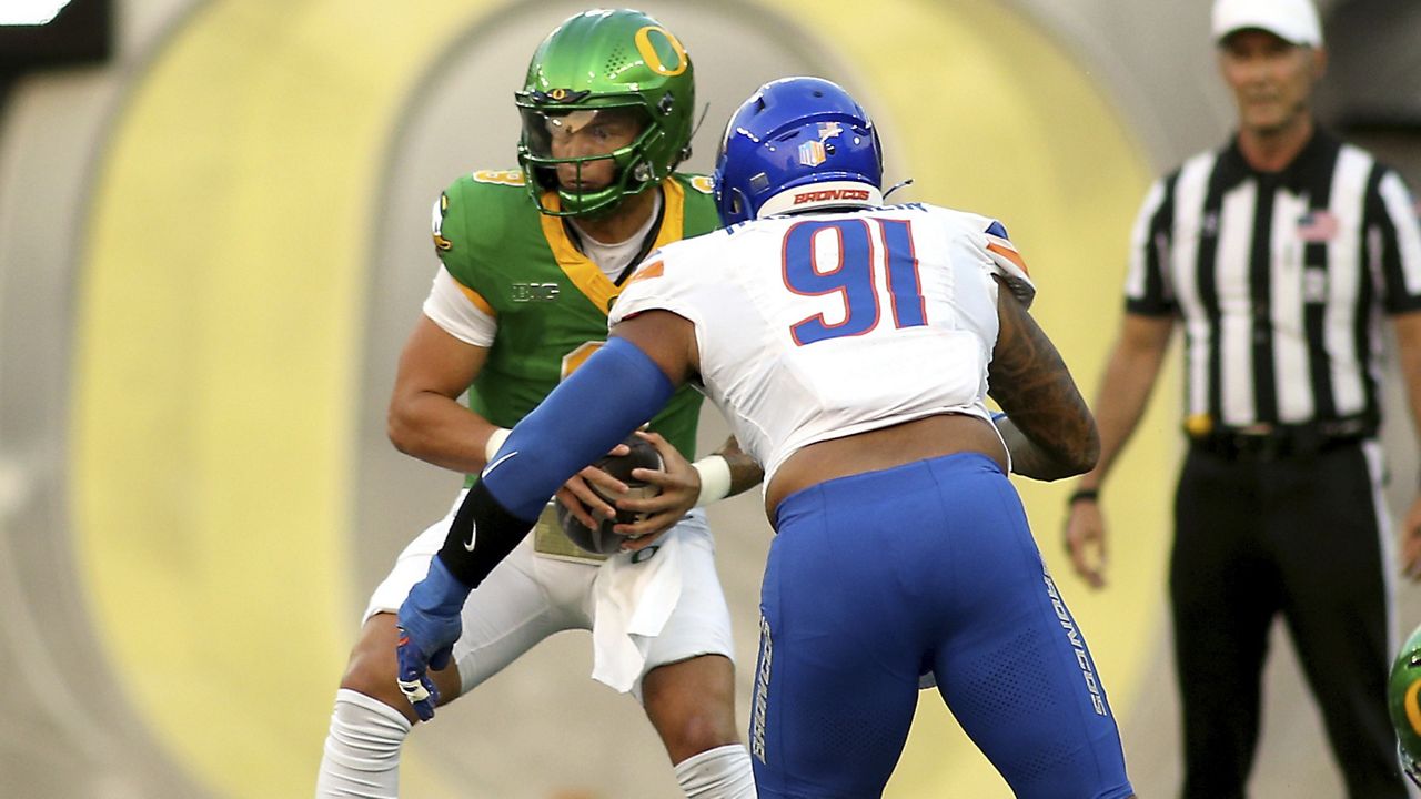 Boise State defensive end Ahmed Hassanein pursued Oregon quarterback Dillon Gabriel in the first half Saturday at Autzen Stadium in Eugene, Ore.