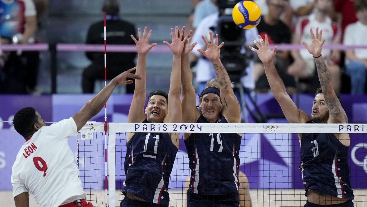 Poland's Wilfredo Leon took a swing against  Micah Christenson (11) Taylor Averill (19) and T.J. Defalco, right, of the U.S. during Wednesday's men's volleyball Olympic semifinal in Paris. Christenson is a Kamehameha graduate and Averill played at the University of Hawaii.