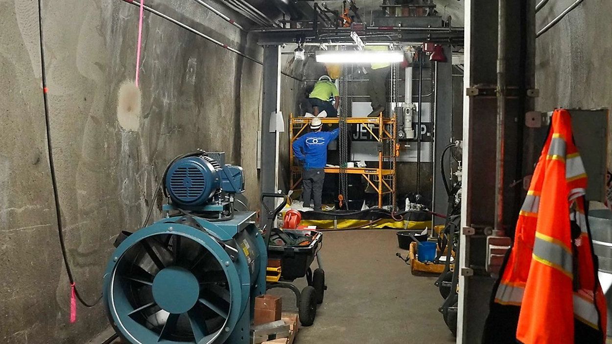 Navy contractors drained residual fuel from a Tank 7 valve into a metal 55-gallon drum prior to connecting a forced-air ventilation system at the Red Hill Bulk Fuel Storage Facility on June 10. (Photo courtesy of U.S. Navy)