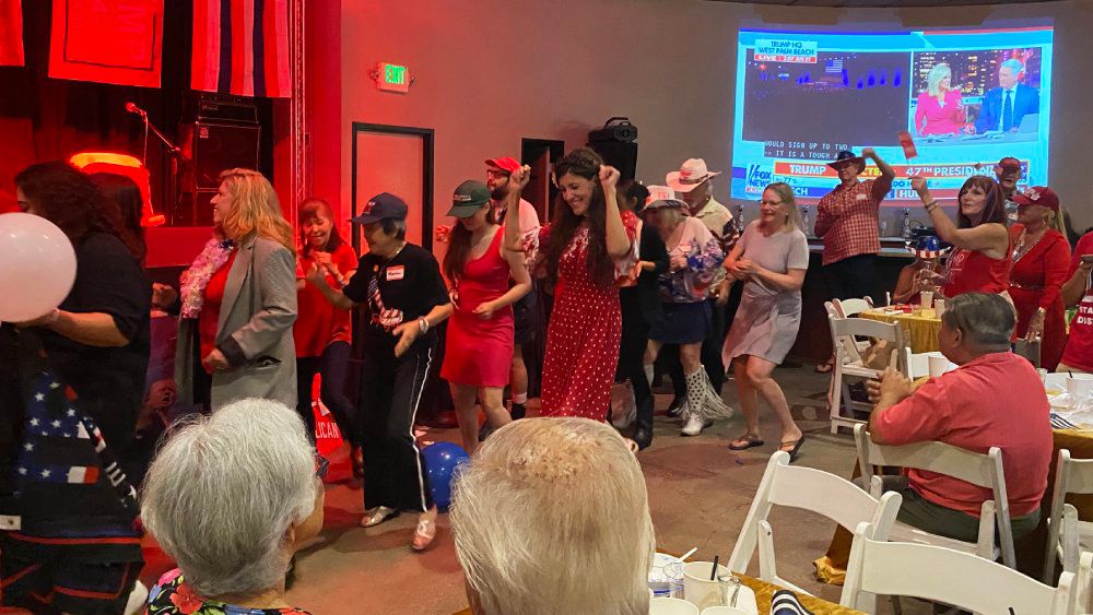 Supporters celebrate Trump's assumed win by dancing the Electric Slide. (Spectrum News/Sarah Yamanaka)