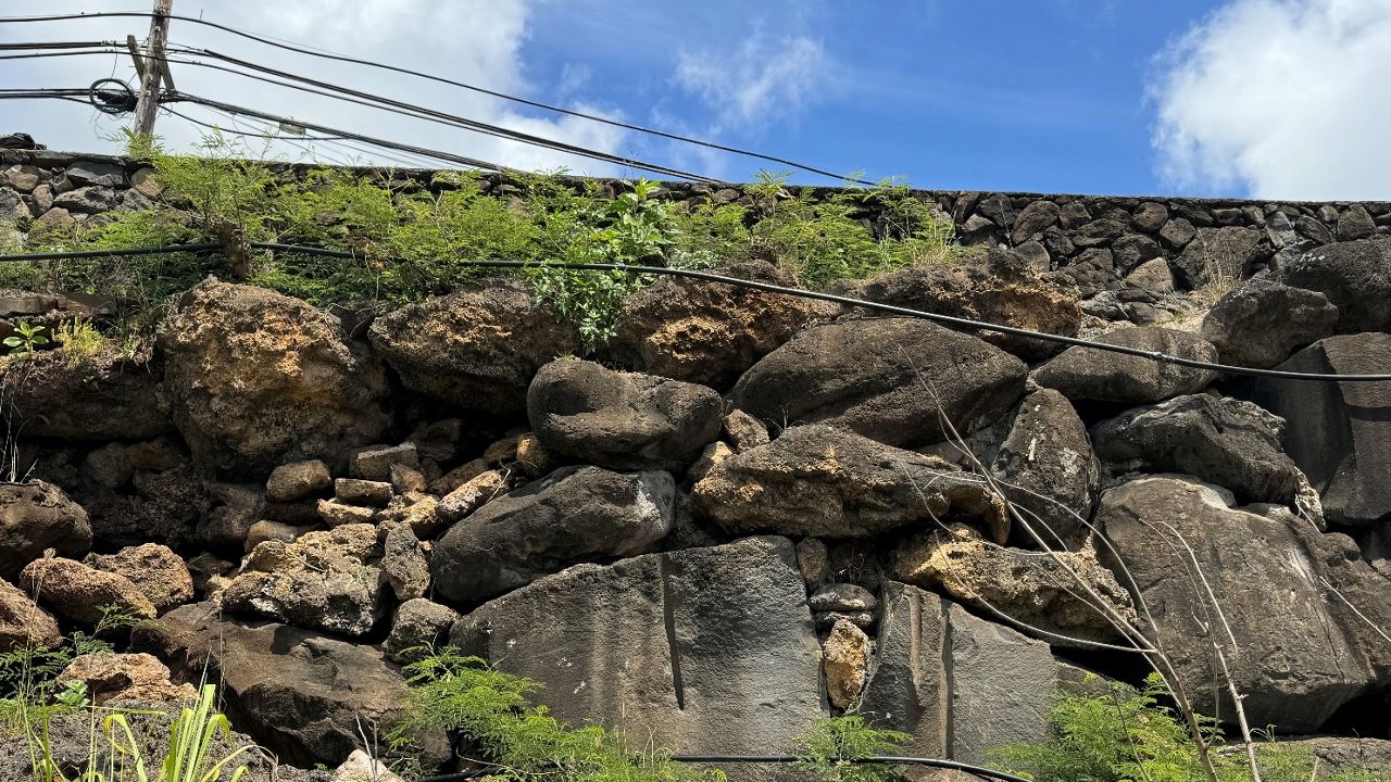 Image shows the distressed rock wall before construction. (Photo courtesy of the City and County of Honolulu)