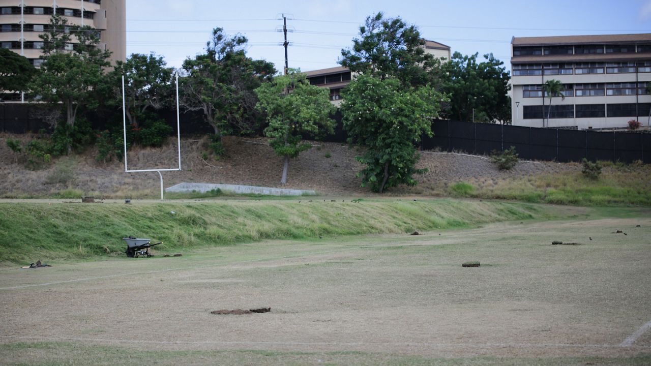 Work began this week on the two-tiered grass of Cooke Field, which will be leveled for a new soccer and track and field venue. (Spectrum News/Brian McInnis)