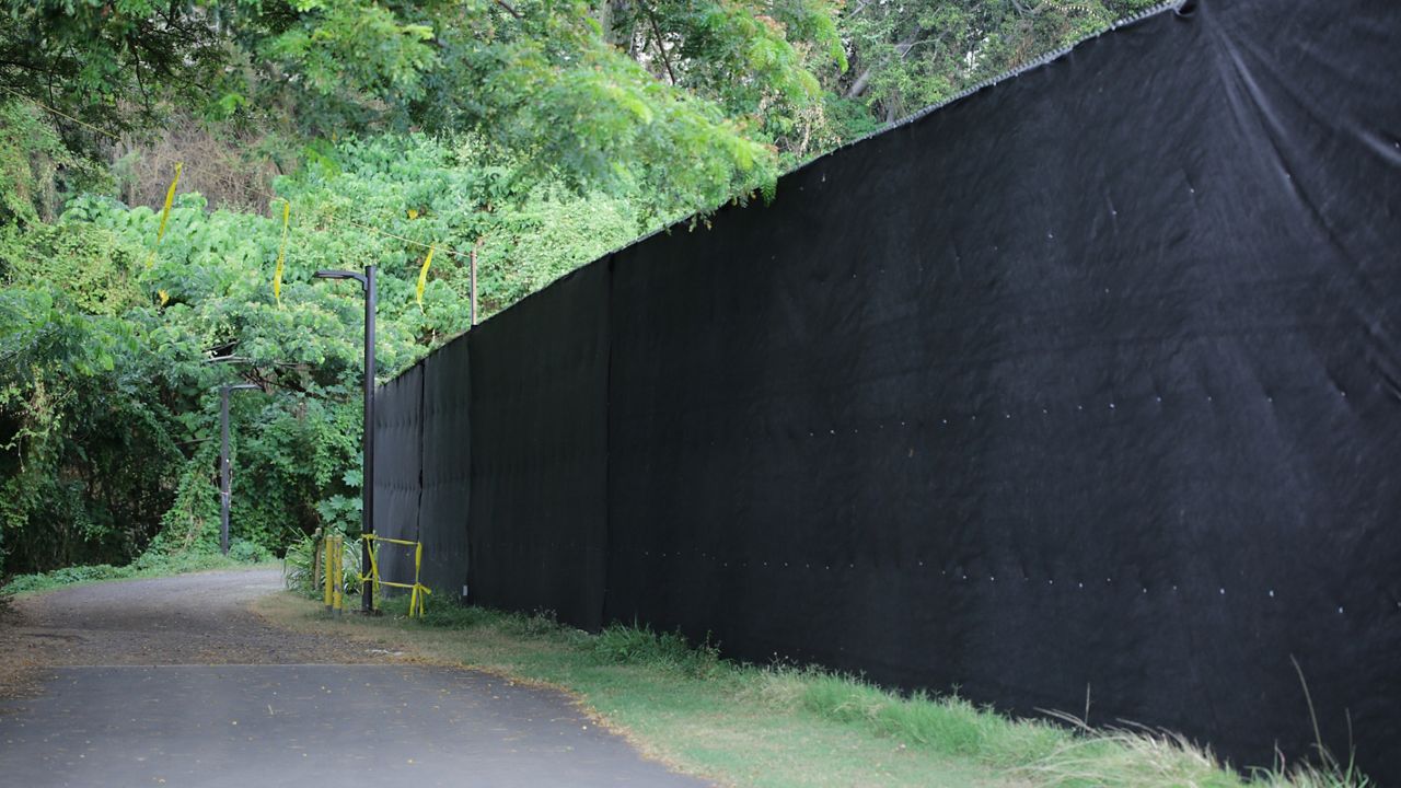 The black construction wall installed around Cooke Field by RMY Construction. (Spectrum News/Brian McInnis)