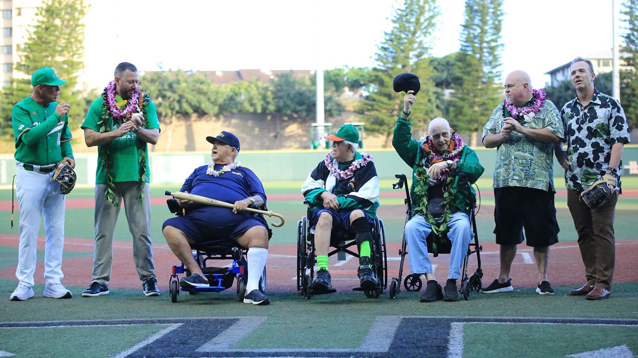 Former Hawaii baseball radio play by play man Don Robbs, third from right, doffed his cap to the fans at Les Murakami Stadium during a pregame ceremony dedicating the Les Murakami Stadium in honor of Robbs and the late Jim Leahey on Thursday. Representing Leahey was his son, Spectrum Sports play-by-play man Kanoa Leahey, second from left. Also from left were UH coach Rich Hill, Spectrum Sports color analyst Pal Eldredge, former UH coach Les Murakami, Spectrum Sports and ESPN Honolulu broadcaster Scott Robbs and UH Athletic Director Craig Angelos.