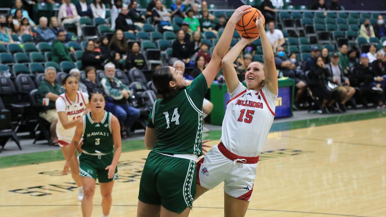 Hawaii center Brooklyn Rewers blocked the shot of Fresno State's Laney Amundsen in the second half on Friday at the Stan Sheriff Center.