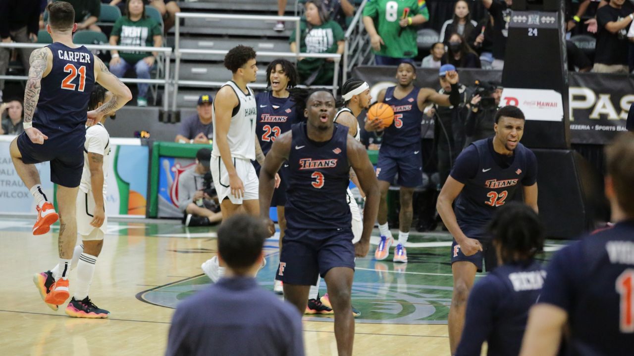 Cal State Fullerton players celebrated after Justin McKoy's desperation 3-pointer from the corner was off the mark and the Titans escaped with their fifth straight victory over the Rainbow Warriors.