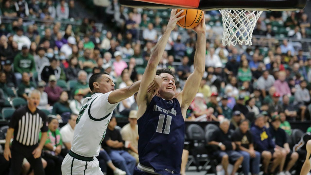 Nevada forward Nick Davidson rose for a baseline dunk, plus the foul from Hawaii's Juan Munoz, in the second half of the Wolf Pack's win over the Rainbow Warriors on Sunday night.