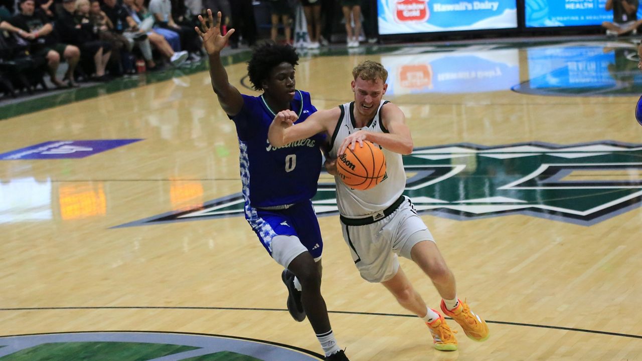 Hawaii wing Ryan Rapp drove the ball against Texas A&M-Corpus Christi guard Leo Torbor at the Stan Sheriff Center on Saturday night.