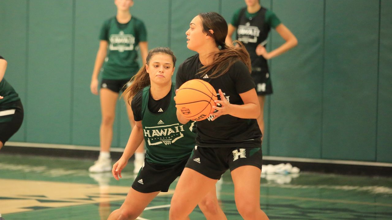 Jovi Lefotu held the ball while guarded by her sister, Lily Wahinekapu, at a Hawaii women's basketball practice in September. Wahinekapu was named to the Big West preseason all-conference team on Tuesday.