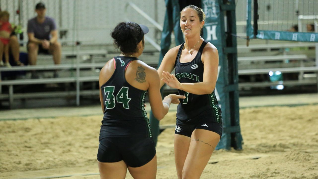 Kaylee Glagau, right, slapped hands with partner Pani Napoleon on senior night against Grand Canyon on April 14. Glagau notched her 100th career dual match victory on Thursday, becoming the third Hawaii player to do so.