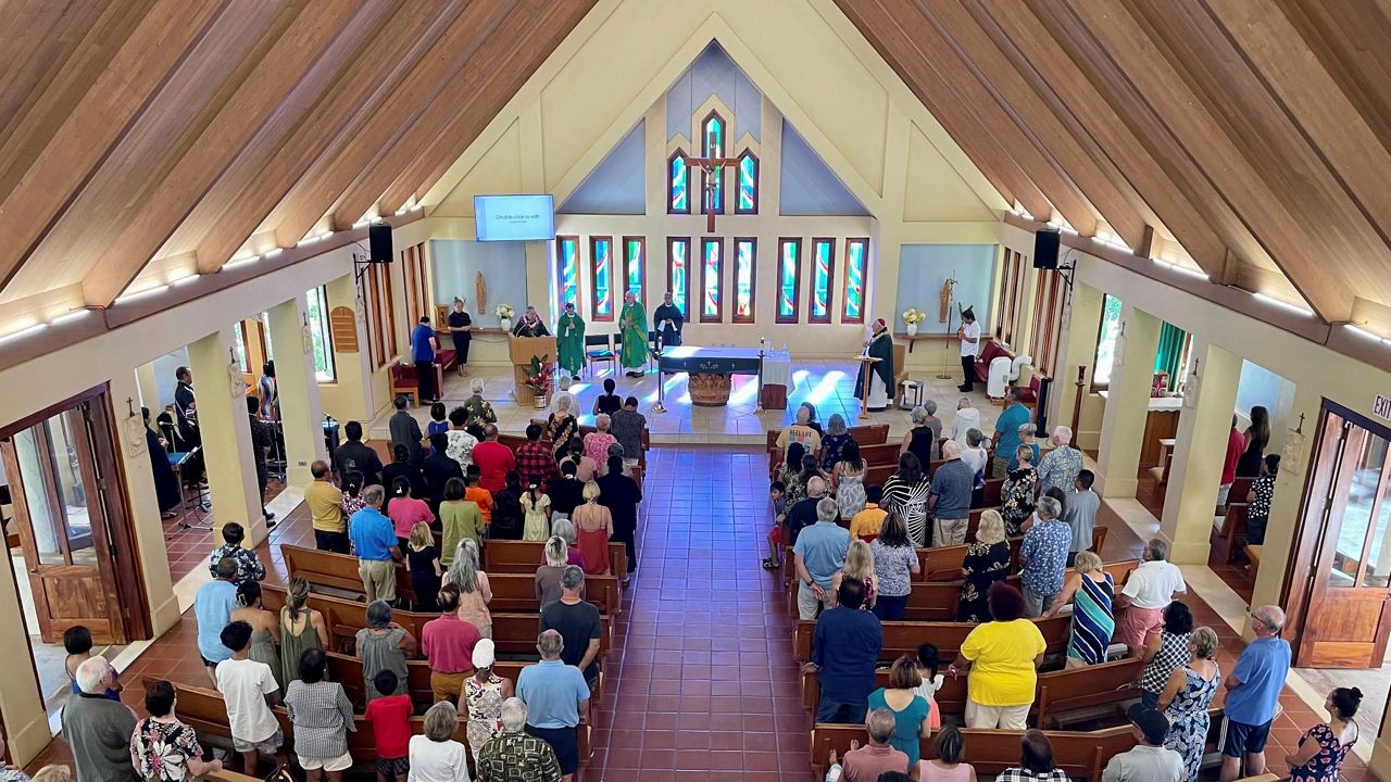 Parishioners attend Mass at Sacred Hearts Mission Church in Kapalua, Hawaii, Sunday, Aug. 13, 2023. Sacred Hearts Mission Church hosted congregants from Maria Lanakila Catholic Church in Lahaina, including several people who lost family members in fires that burned most of the Maui town days earlier. (AP Photo/Haven Daley)