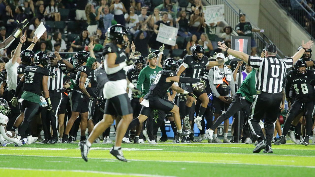 The Hawaii sideline erupted after linebacker Noah Kema (18) came away with a fourth-quarter interception against Air Force last week. In the foreground is cornerback Cam Stone (4), a former Wyoming player who will face his former team on Saturday. 