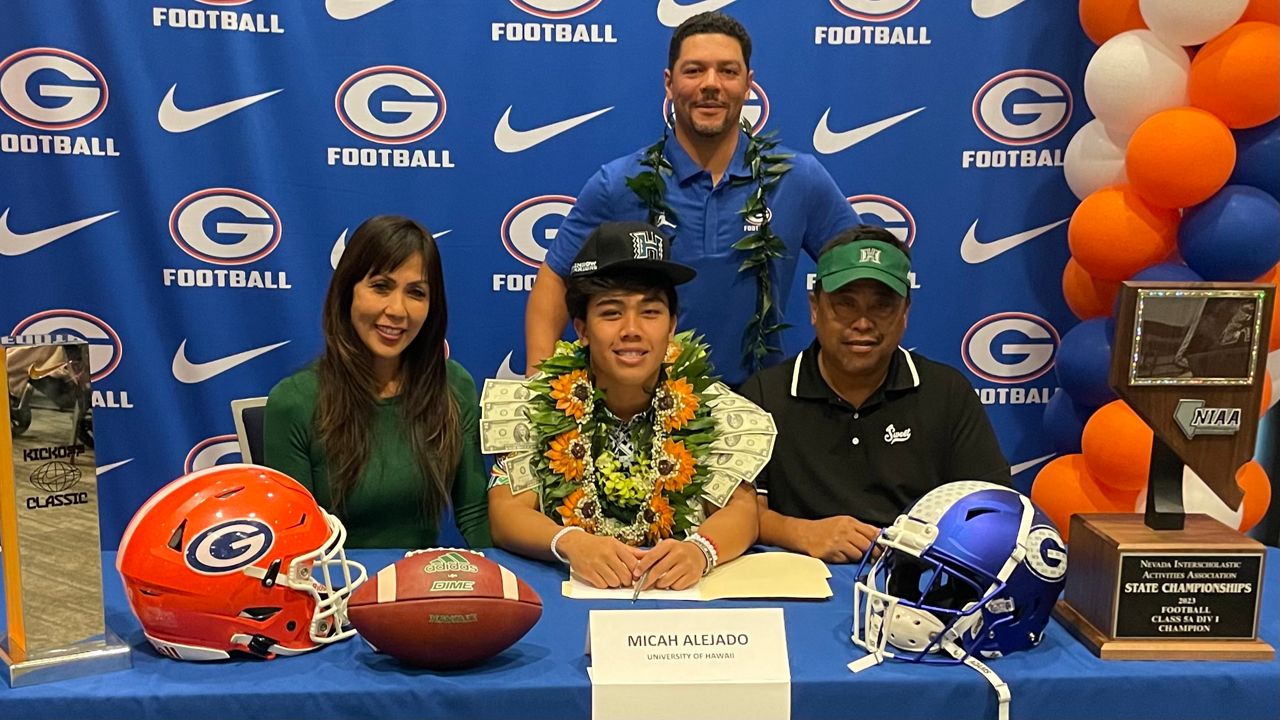 Bishop Gorman (Nev.) quarterback Micah Alejado gathered with his family and Gaels coach Brent Browner, top, for Wednesday's signing day ceremony. Alejado signed with Hawaii as part of the Rainbow Warriors' 2024 recruiting class.