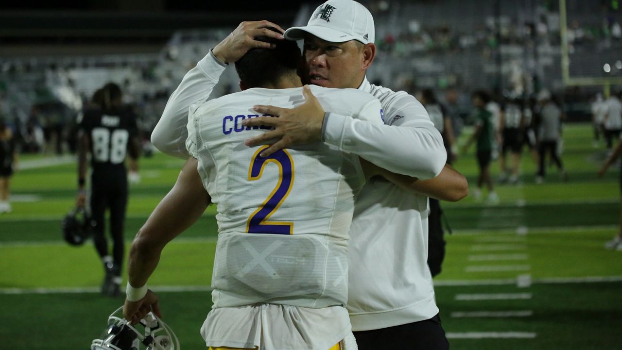Hawaii football coach Timmy Chang, right, hugged San Jose State quarterback Cordeiro after Cordeiro, an ex-UH signal-caller who graduated from Saint Louis School, led the Spartans to a 35-0 road win over the Rainbow Warriors.