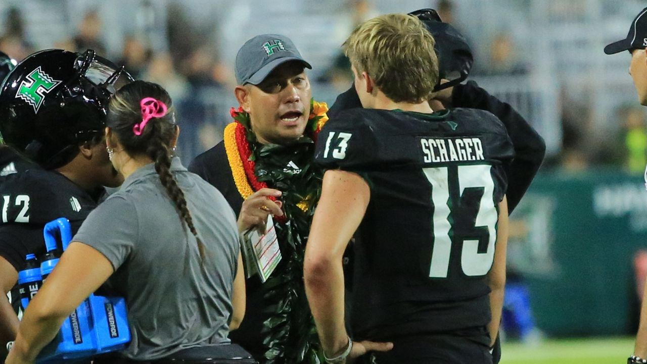 Hawaii football coach Timmy Chang spoke to quarterback Brayden Schager in UH's game against Nevada on Oct. 26.