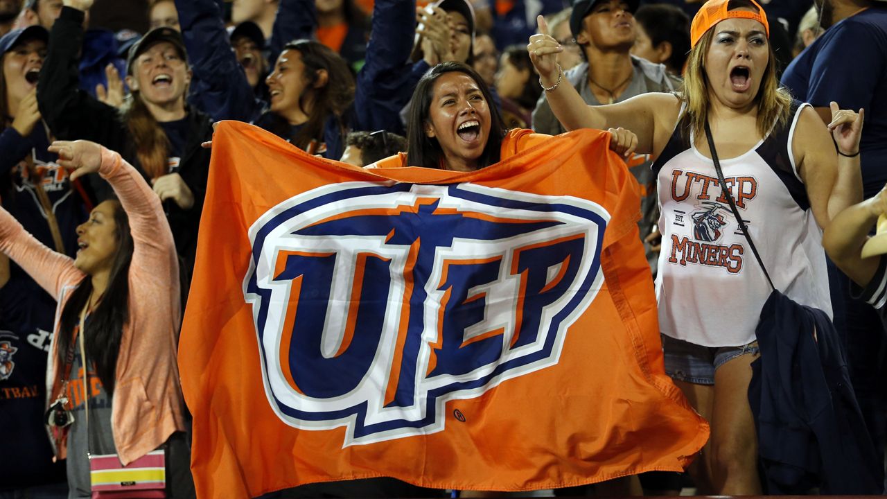 UTEP fans celebrate their team's 50-47 football win over New Mexico State on Sept. 19, 2015.