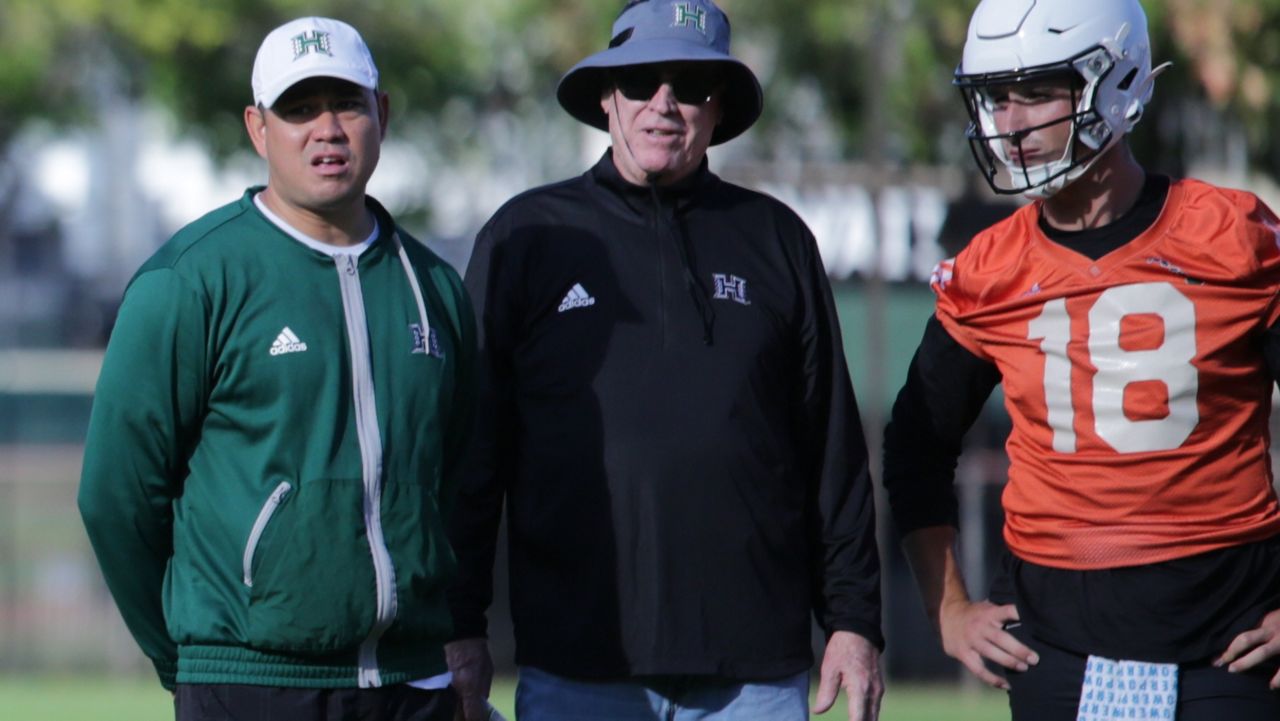 Dan Morrison, middle, watched a Hawaii football fall practice as an observer next to head coach Timmy Chang and then-UH backup quarterback Joey Yellen in fall 2023.