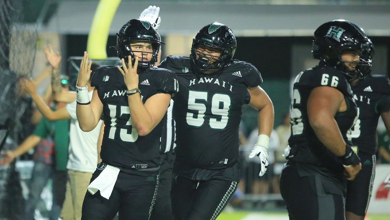 Hawaii quarterback Brayden Schager, left, held up "4s" after his fourth rushing touchdown of the night against Nevada at the Clarence T.C. Ching Athletics Complex on Saturday. 