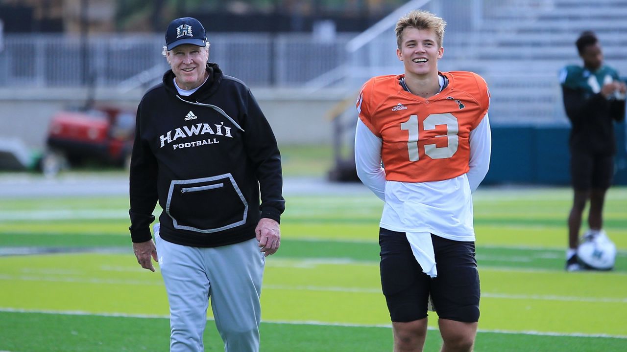 Hawaii quarterback Brayden Schager, right, and quarterbacks coach Dan Morrison walked off the field during a practice in February. Schager and the Rainbow Warriors were picked to finish ninth of 12 teams in the Mountain West media preseason poll announced Wednesday.