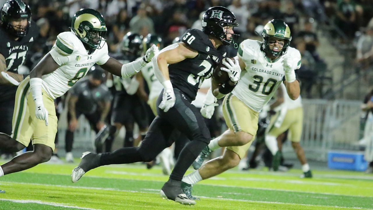 Hawaii running back Landon Sims took off with the ball against Colorado State in the 2023 season finale on Nov. 25. CSU was one of four Mountain West schools who on Thursday officially joined the Pac-12 Conference starting in 2026. (Spectrum News/Brian McInnis)