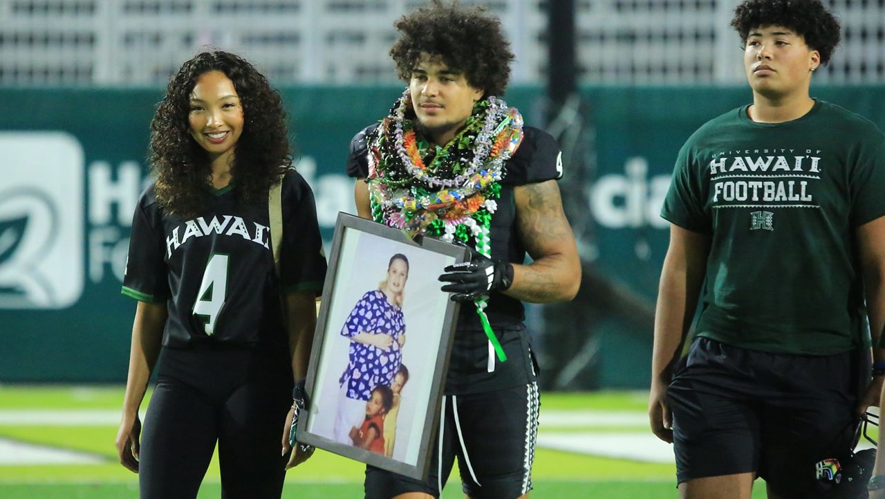 Hawaii cornerback Cam Stone, middle, did his senior walk Saturday after helping the Rainbow Warriors beat New Mexico 38-30 in the 2024 season finale.