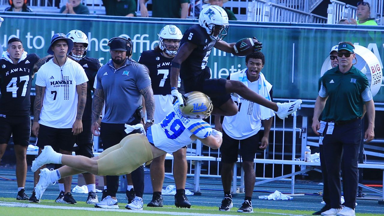 Hawaii receiver Pofele Ashlock was knocked out of bounds by UCLA's Carson Schwesinger in the third quarter.