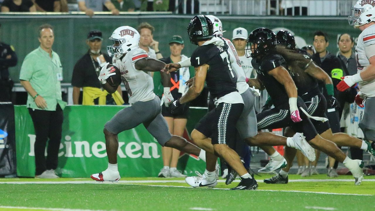 UNLV running back Jai'Den Thomas outran the Hawaii defense for a 32-yard touchdown in the fourth quarter as UH Athletic Director Craig Angelos, far left, looked on. 