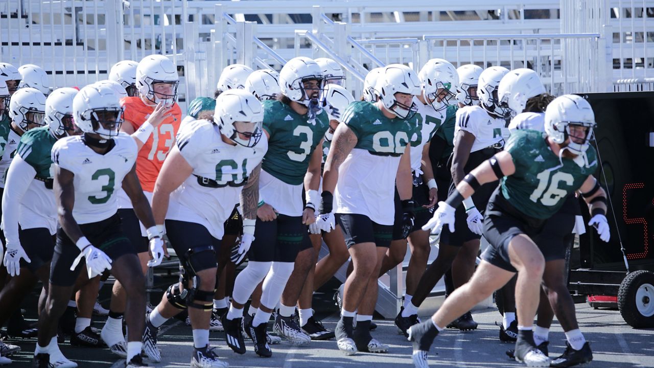 Linebacker Logan Taylor, right, led the Rainbow Warriors out of the tunnel underneath new seating at the Clarence T.C. Ching Athletics Complex for a team scrimmage on Saturday.