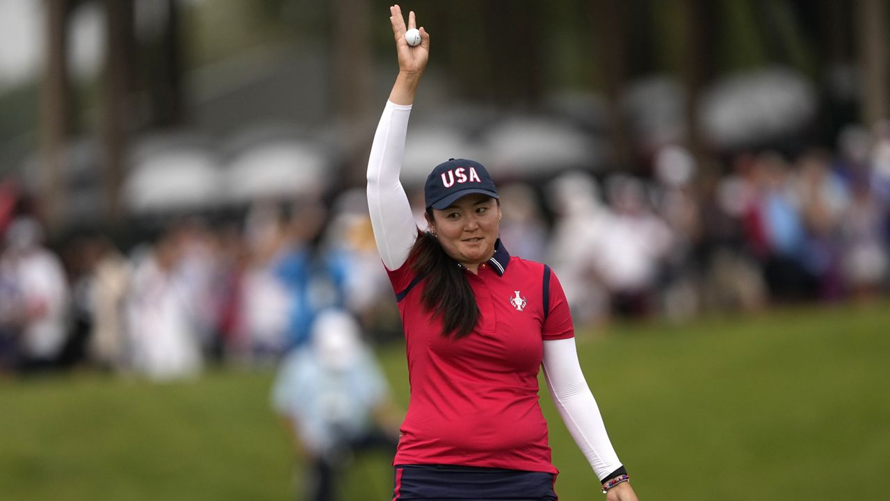 Punahou School alumna Allisen Corpuz celebrated on the 16th green after winning her foursomes match for the U.S. on Day 1 of the Solheim Cup at Robert Trent Jones Golf Club in Gainesville, Va., on Friday. 