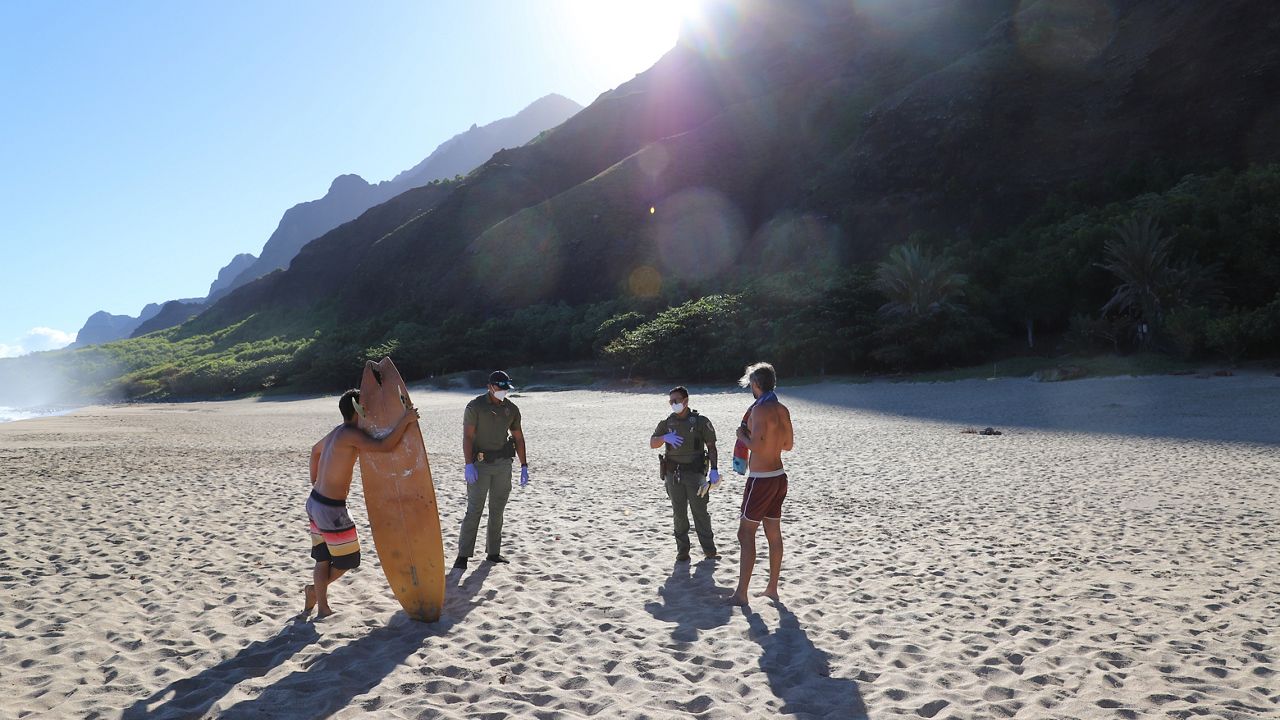 DOCARE officers inform people in Kalalau Valley of the closure. (Courtesy of Hawaii Department of Land & Natural Resources)