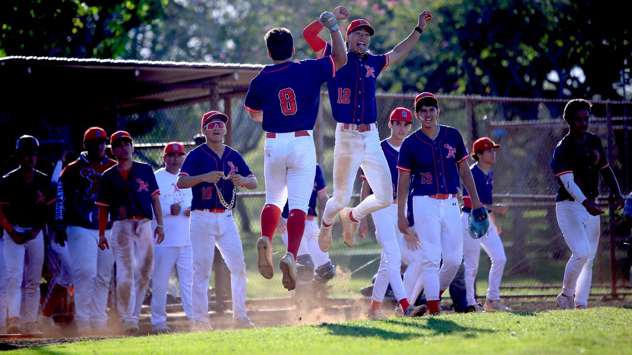 Saint Louis celebrated when senior Sean Yamaguchi (8) came in to score the clinching run on a wild pitch in the fifth inning to decide the ILH baseball first-round title in a playoff with Kamehameha at Central Oahu Regional Park on Tuesday. Meeting Yamaguchi in midair was Tanner Chun. 