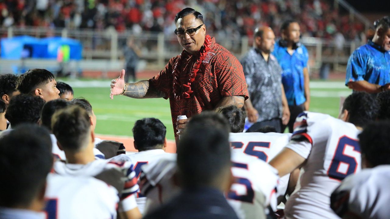 Saint Louis coach Tupu Alualu spoke to his players at the team's game at Kahuku on Aug. 10.