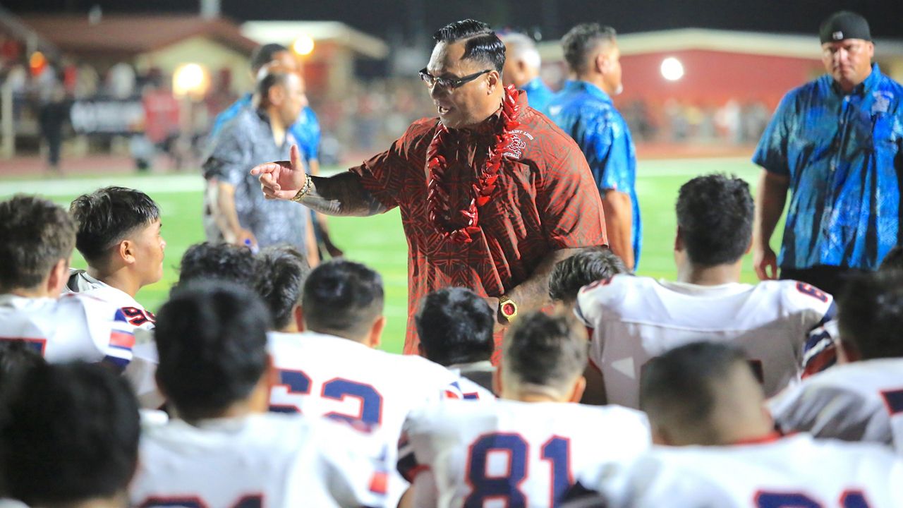 Saint Louis football coach Tupu Alualu spoke to his team at halftime of the season opener at Kahuku on Aug. 10. 