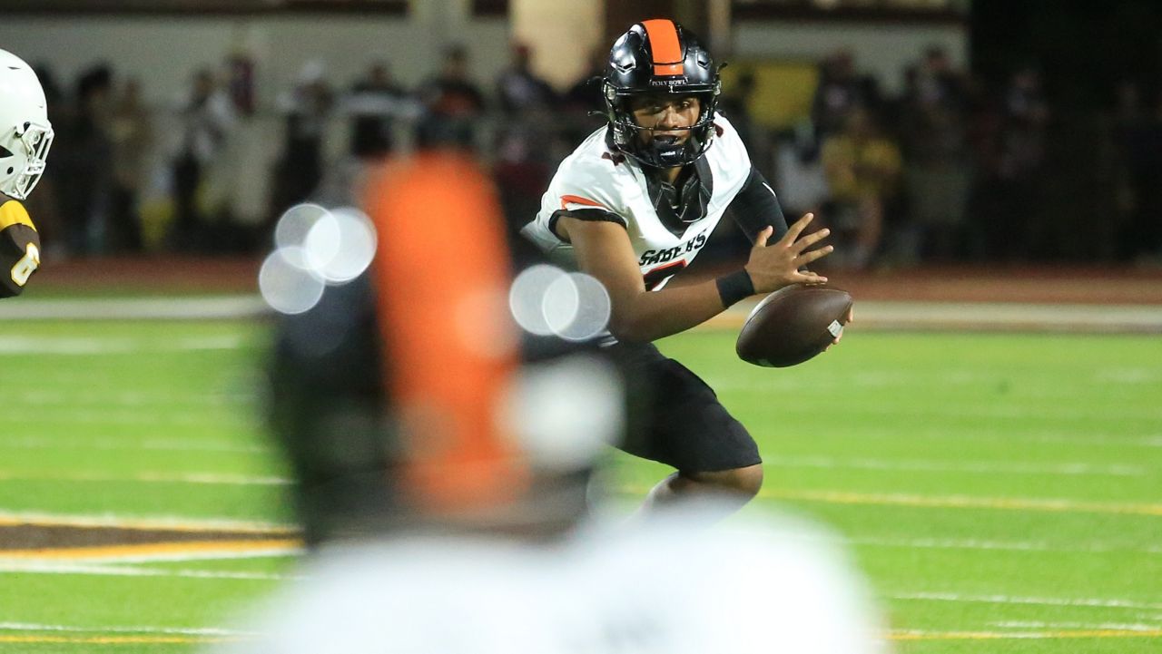 Campbell senior quarterback Jaron-Keawe Sagapolutele rolled out and looked for an open receiver in the Sabers' 41-20 win at Mililani on Saturday night.