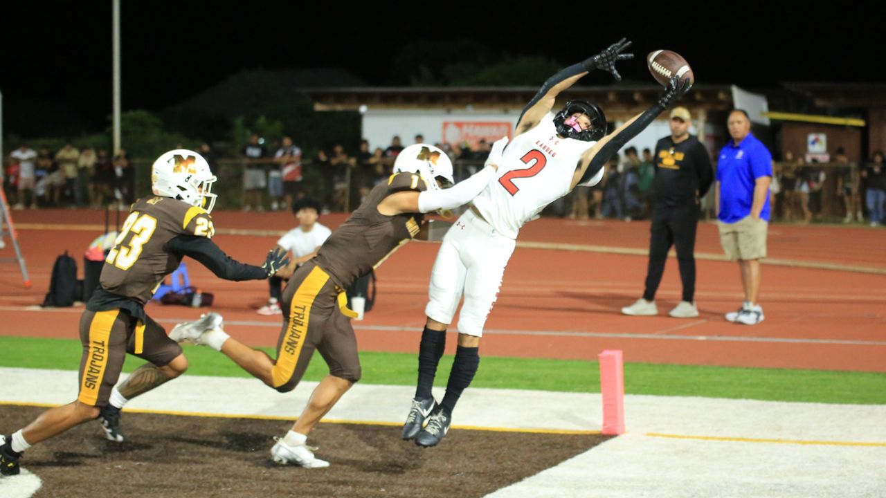 Mililani defensive back Jonah Togafau-Tavui (1) made things more difficult for Kahuku receiver Kaimana Carvalho on an incomplete ball in the back corner of the end zone at John Kauinana Stadium on Saturday night. 