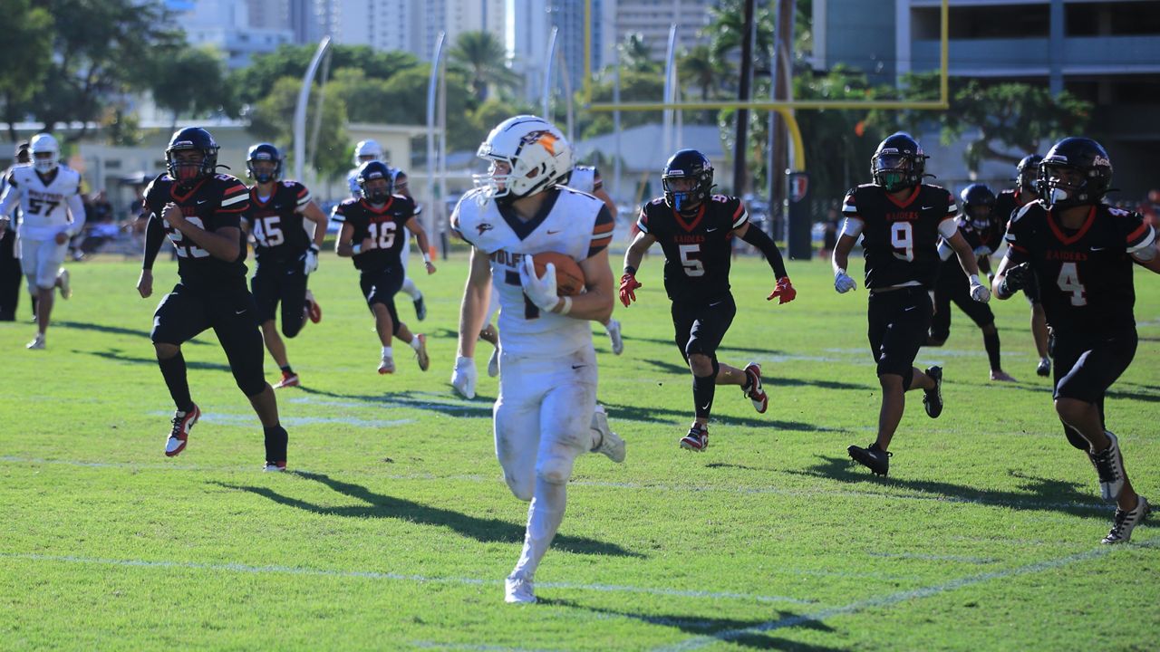 Pac-Five running back Seth Miller took the ball downfield while he was pursued by the Iolani football team in the third quarter at Eddie Hamada Field on Friday. 