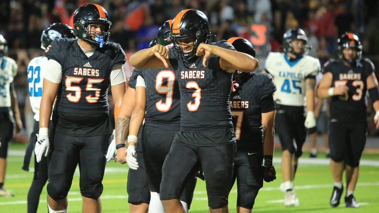 Campbell quarterback Jaron-Keawe Sagapolutele (3) celebrated after his 13-yard touchdown connection with receiver Shaison Kupukaa (9) in the fourth quarter as the go-ahead score over Kapolei at Mililani on Friday night.