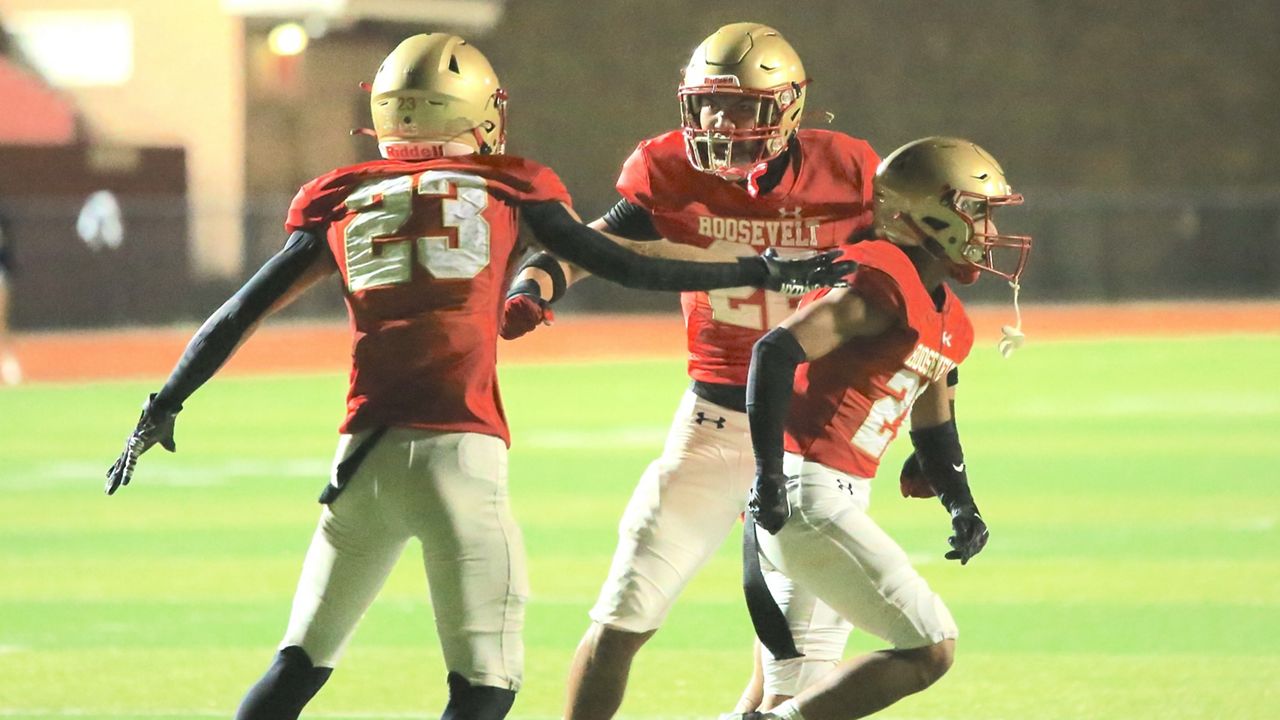 Roosevelt players Javon Martin-Wolfe, middle, Bobby Sousa, left, and Dayten Tilton, right, celebrated a goal-line stand against Kamehameha-Hawaii in the first half of their HHSAA Division II first-round game at Ticky Vasconcellos Stadium on Saturday night.