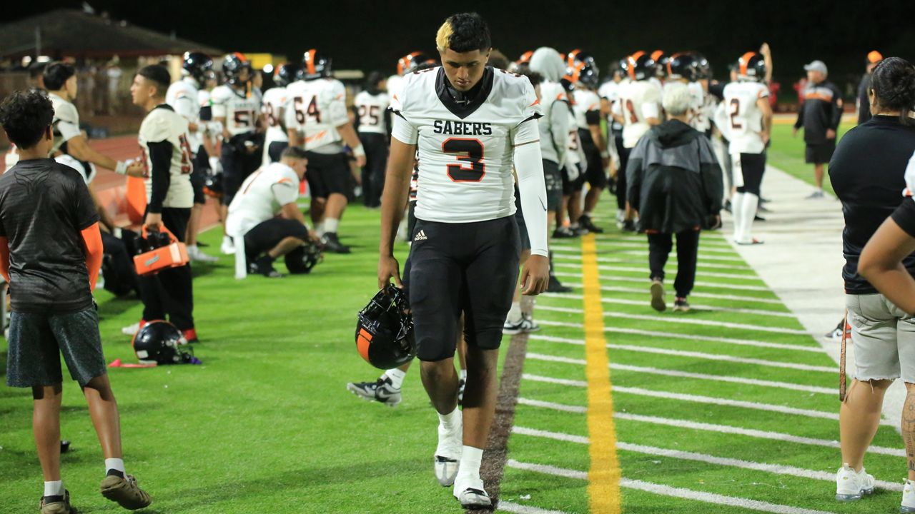 A dejected Jaron-Keawe Sagapolutele walked along the Campbell sideline in the final moments of a state semifinal loss to Saint Louis at Mililani's John Kauinana Stadium on Friday night.