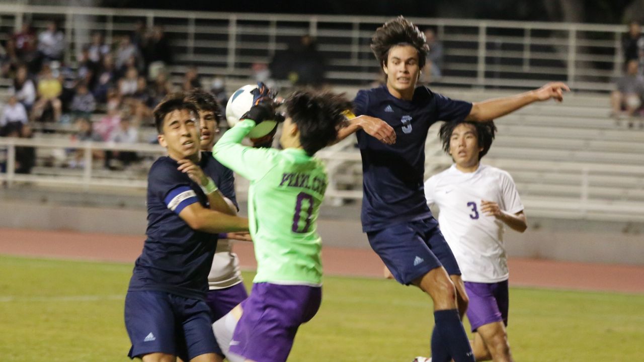 Kailua forwards Brody Person (9) and Kai Fraser, left, challenged Pearl City's goalkeeper in the OIA boys soccer quarterfinals on Tuesday night at Radford.
