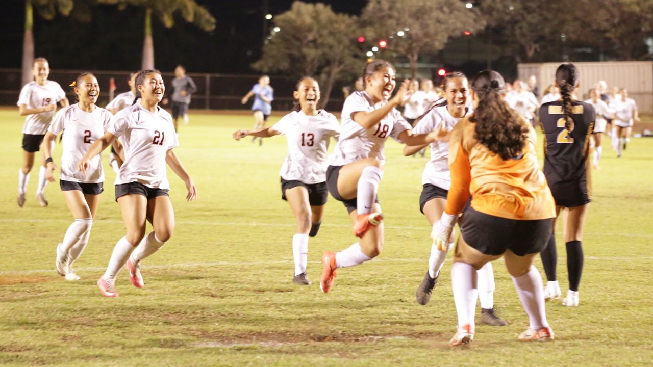 Campbell players rushed goalkeeper Amaris Ishikawa after she stopped Mililani's final penalty kick to give the Sabers the OIA Division I title.