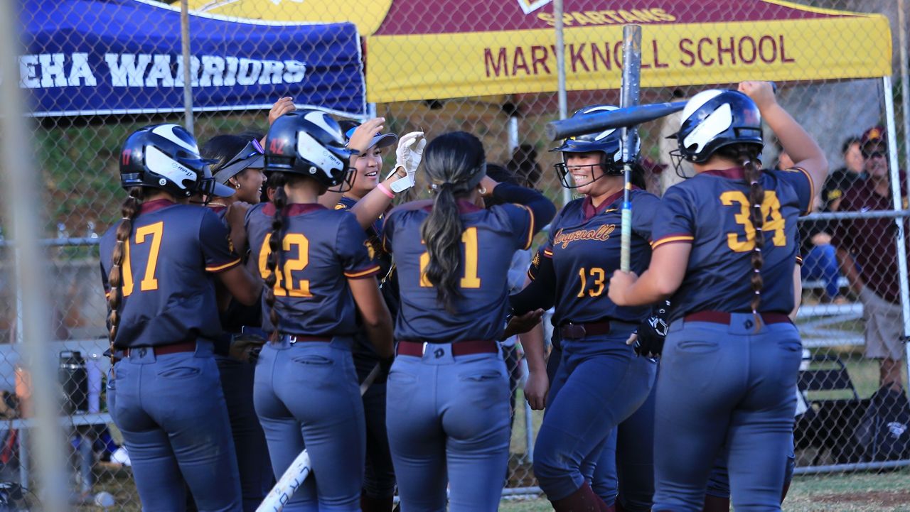 Maryknoll teammates mobbed star Jenna Sniffen (13) as she arrived at home plate upon her third home run against Kamehameha on Tuesday.