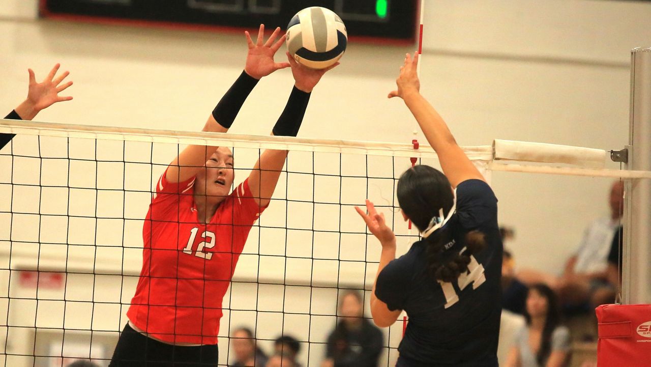 Iolani hitter Callie Pieper put up a block against Kamehameha's Kala Chock at the Raiders' gym on Saturday.