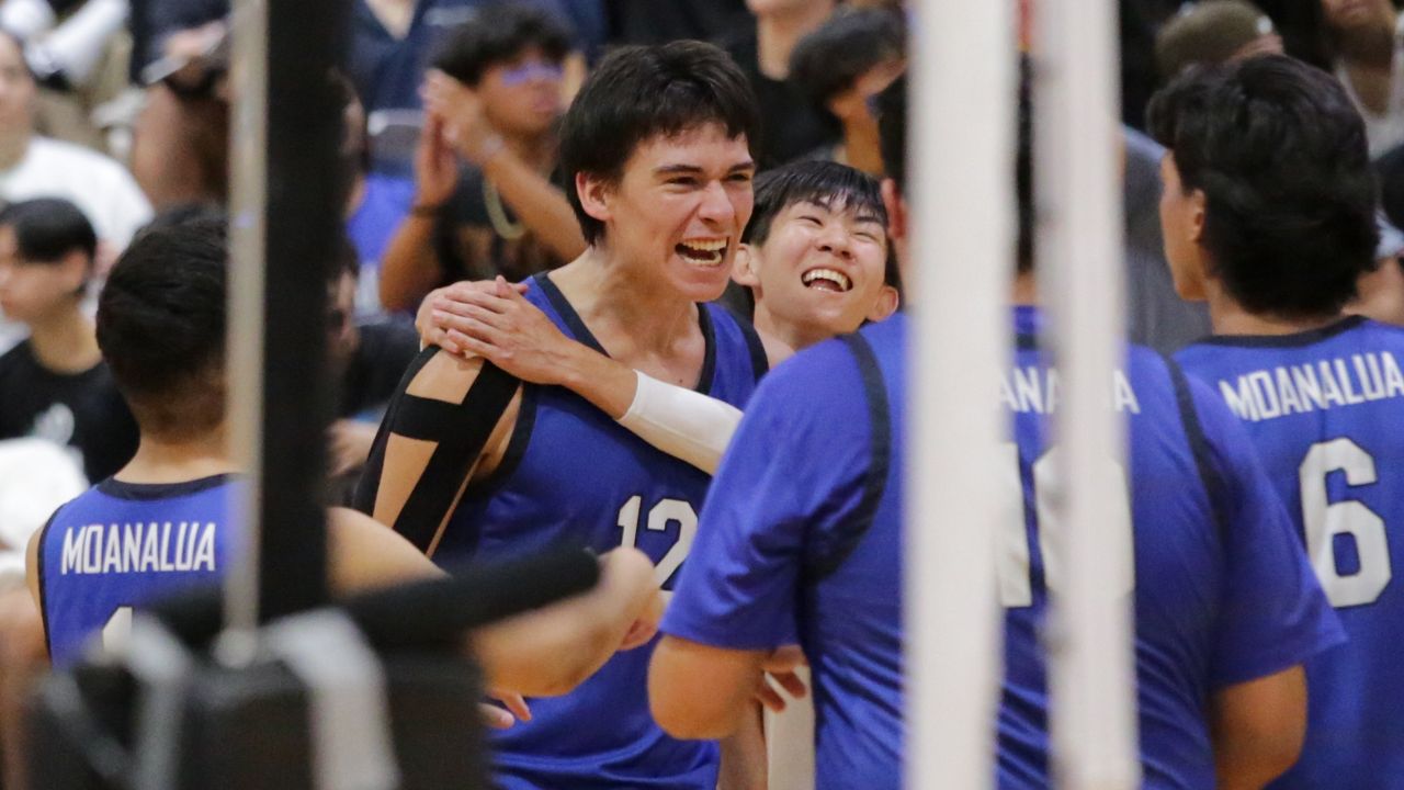 Moanalua hitter Kai Rodriguez, middle, got a hug from libero Kaden Sato after one of his seven aces against Mililani in the OIA Division I championship at Radford on Wednesday night.