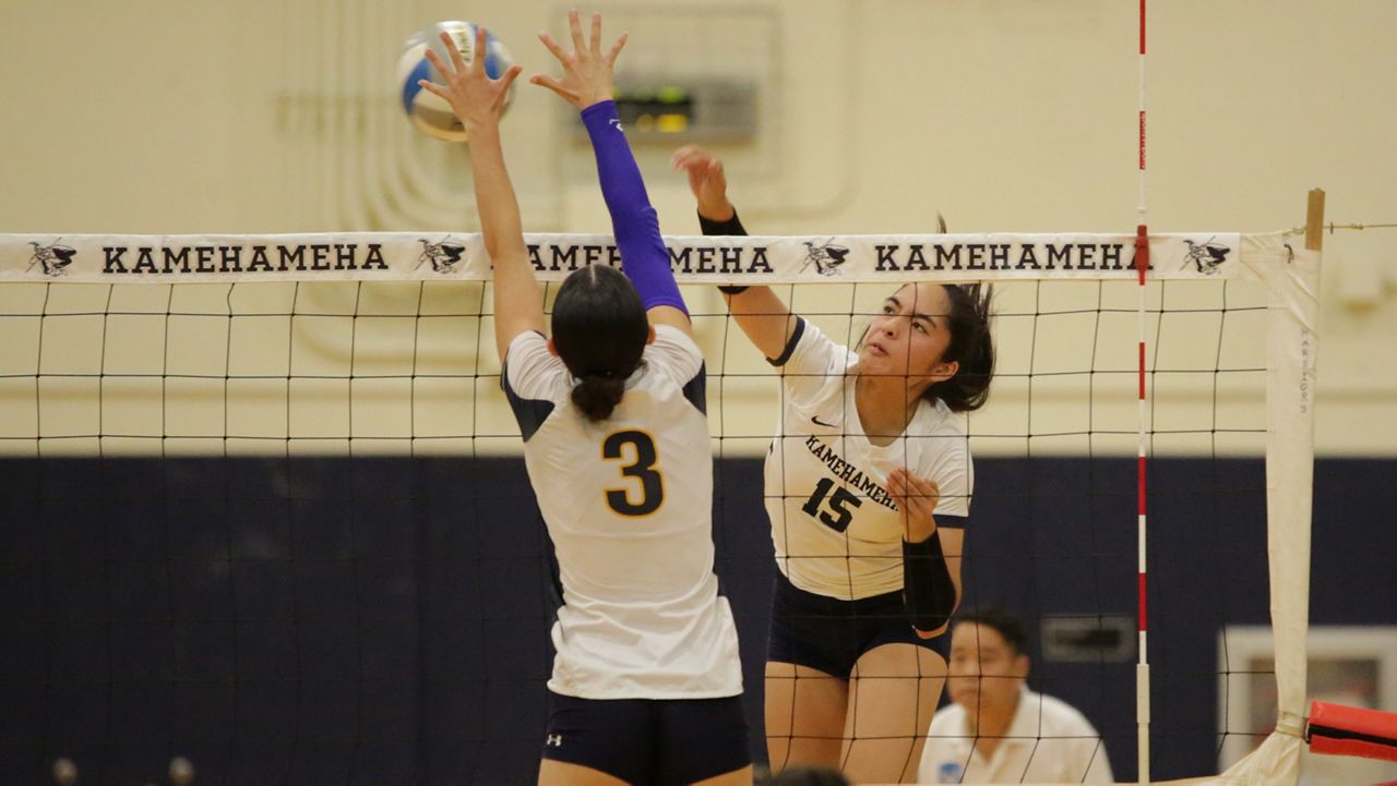 Kamehameha's Kamanao‘okalani Goldstein went up for a swing against Punahou's Rella Binney at Kekuhaupio Gym on Wednesday.