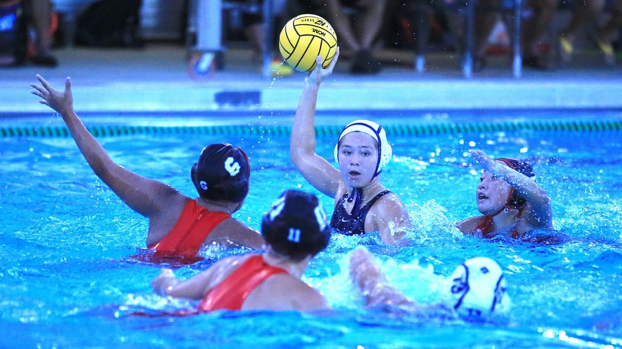 Kamehameha attacker Isabella Kapili looked for an opening against three Iolani defenders on Friday.