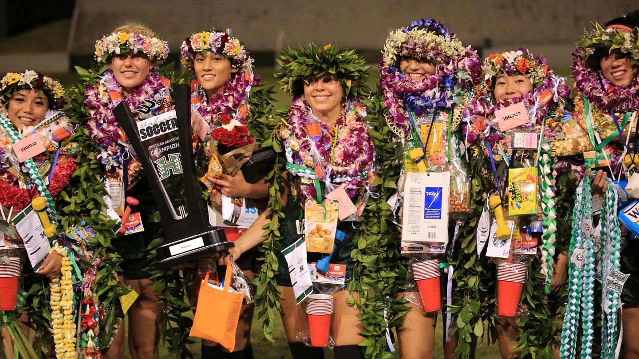 Hawaii soccer players, from left, Amber Gilbert, Mia Foster, Brynn Mitchell, Fabiola Zamora, Carley Park, Nicole Ando and Jacey Jicha, celebrated senior night with a Big West championship trophy following a 1-0 win over Long Beach State at Waipio Peninsula Soccer Stadium on Thursday.